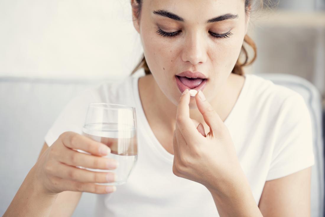 woman taking pill