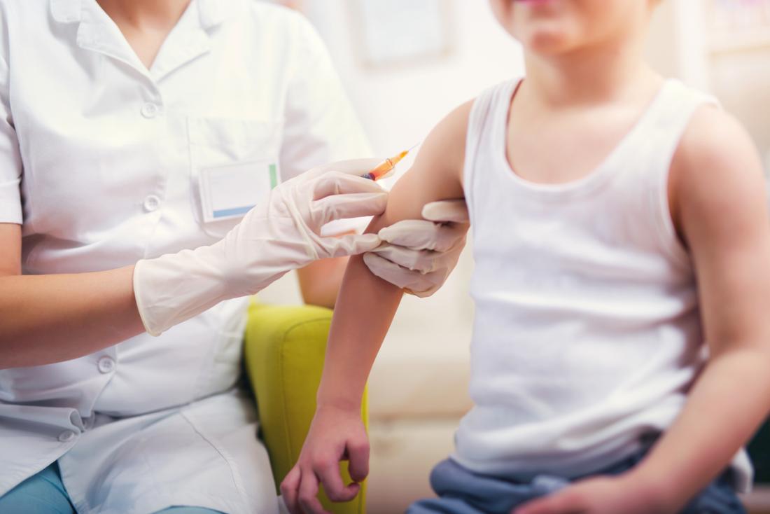 Child receiving vaccination shot.
