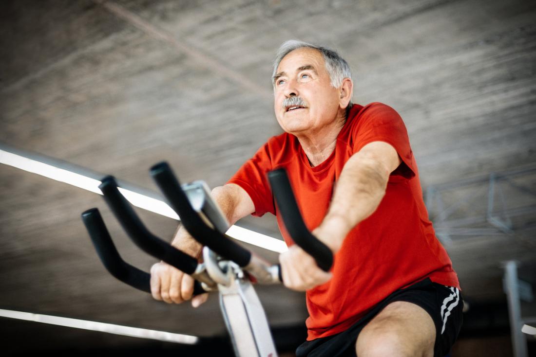 Old man on exercise bike