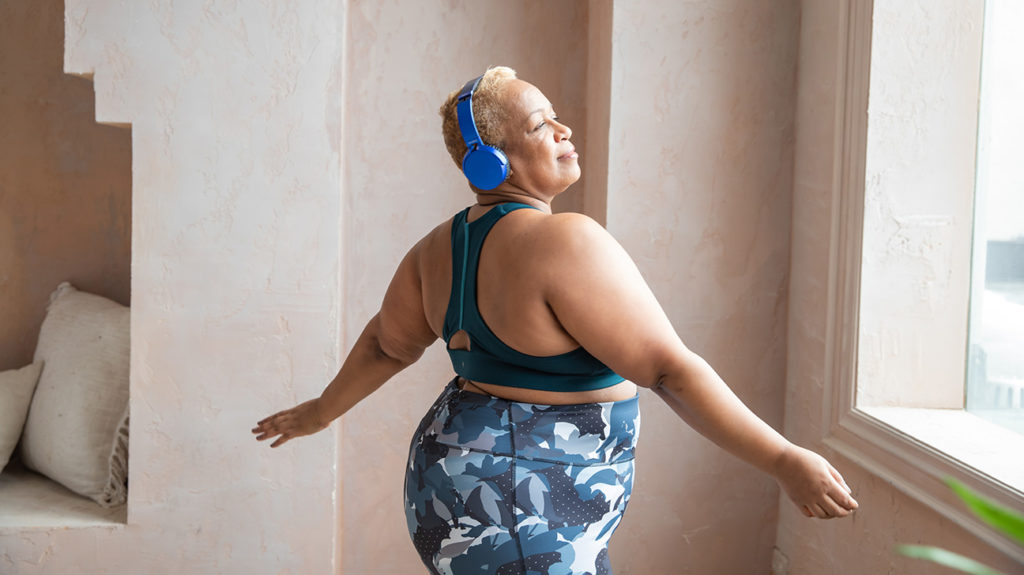 a woman listening to music as a way to lower stress